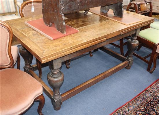 An oak drawleaf refectory table 256cm extended